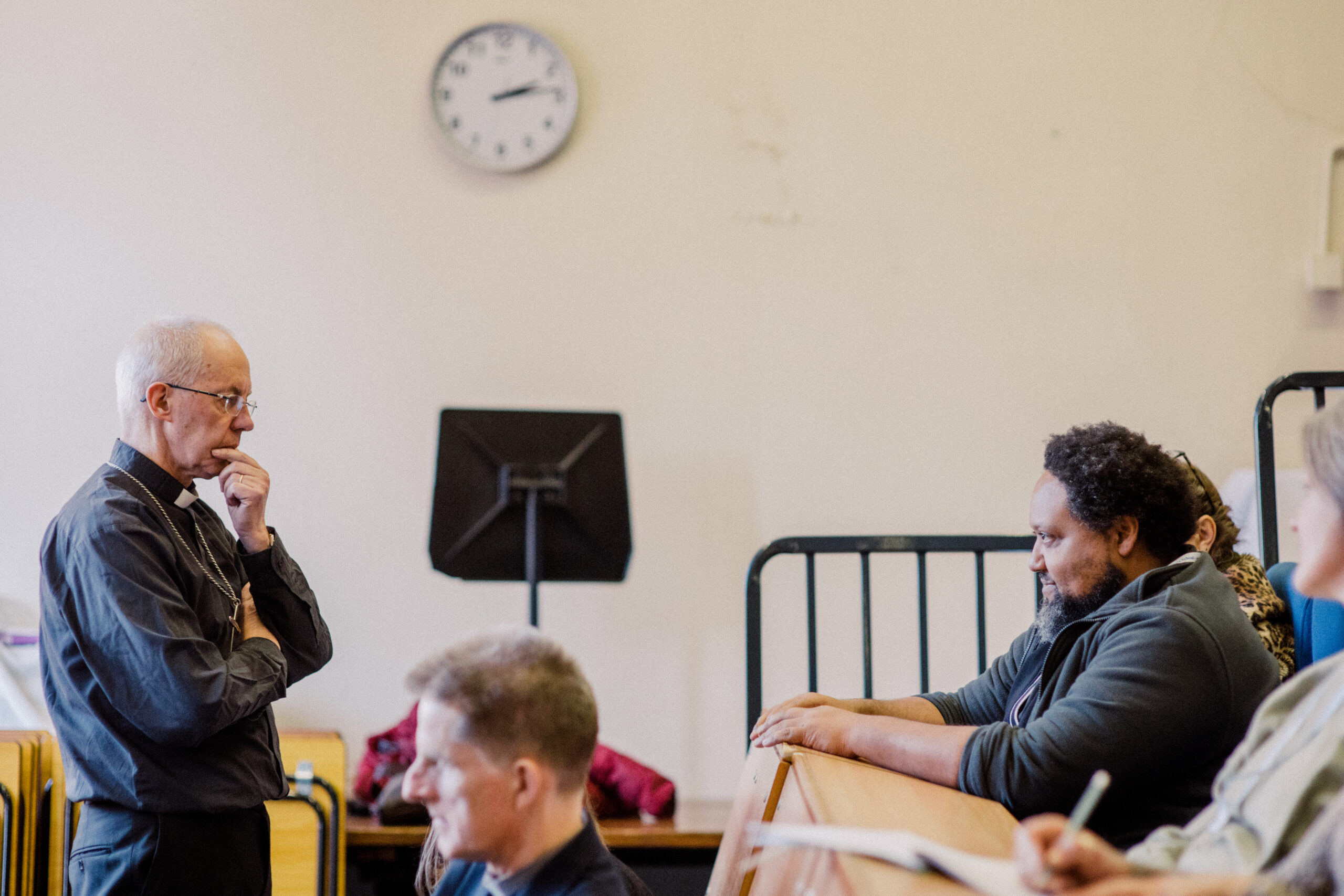 Archbishop of Canterbury Justin Welby stands opposite a guest of the event and consider's the man's question, at the St Augustine's 2023 Residential Week.