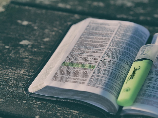 The Bible An opened Bible on a desk with a highlighter pen. Some of the text is highlighted in green.